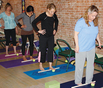 Jenny Otto teaches polework techniques to yoga class